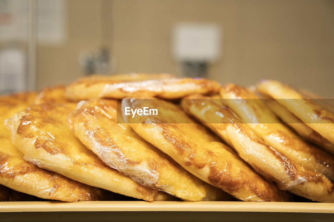 food, food and drink, freshness, no people, indoors, dish, business, meal, close-up, cuisine, focus on foreground, healthy eating, business finance and industry, fast food, wellbeing, snack, store, large group of objects, breakfast, still life, produce, abundance, bread, selective focus, bakery, dessert, asian food, food and drink industry, baked, table