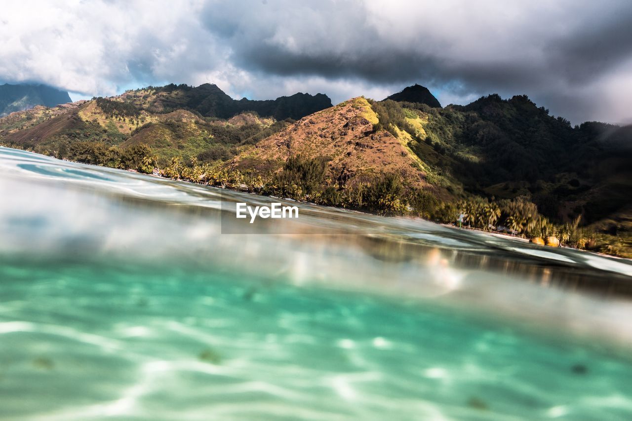 Scenic view of mountains against cloudy sky