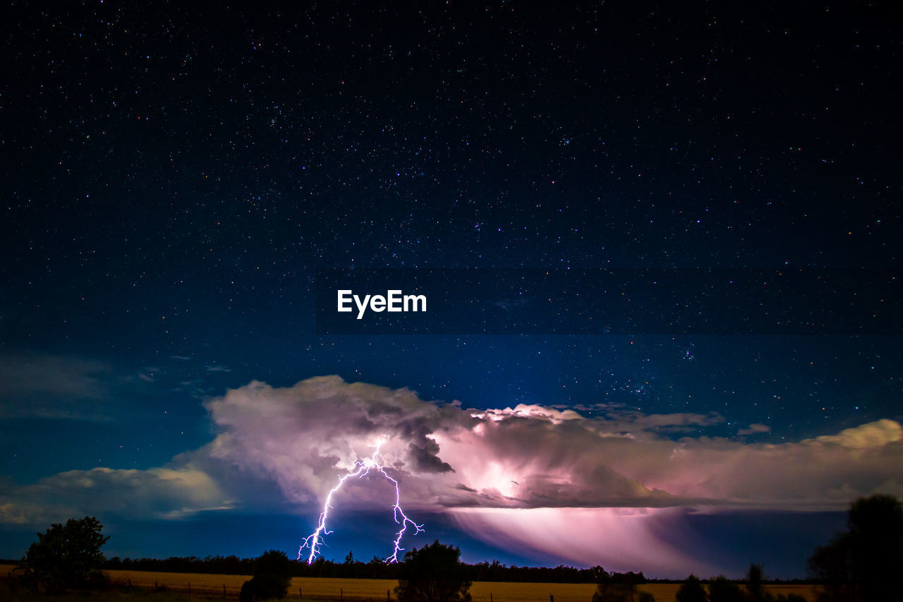 Low angle view of lightning against sky at night