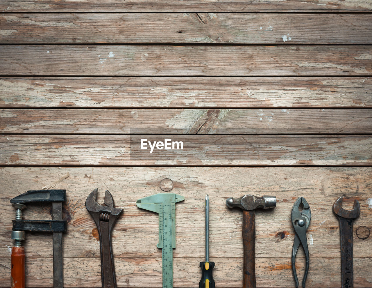 High angle view of hand tools on wooden table