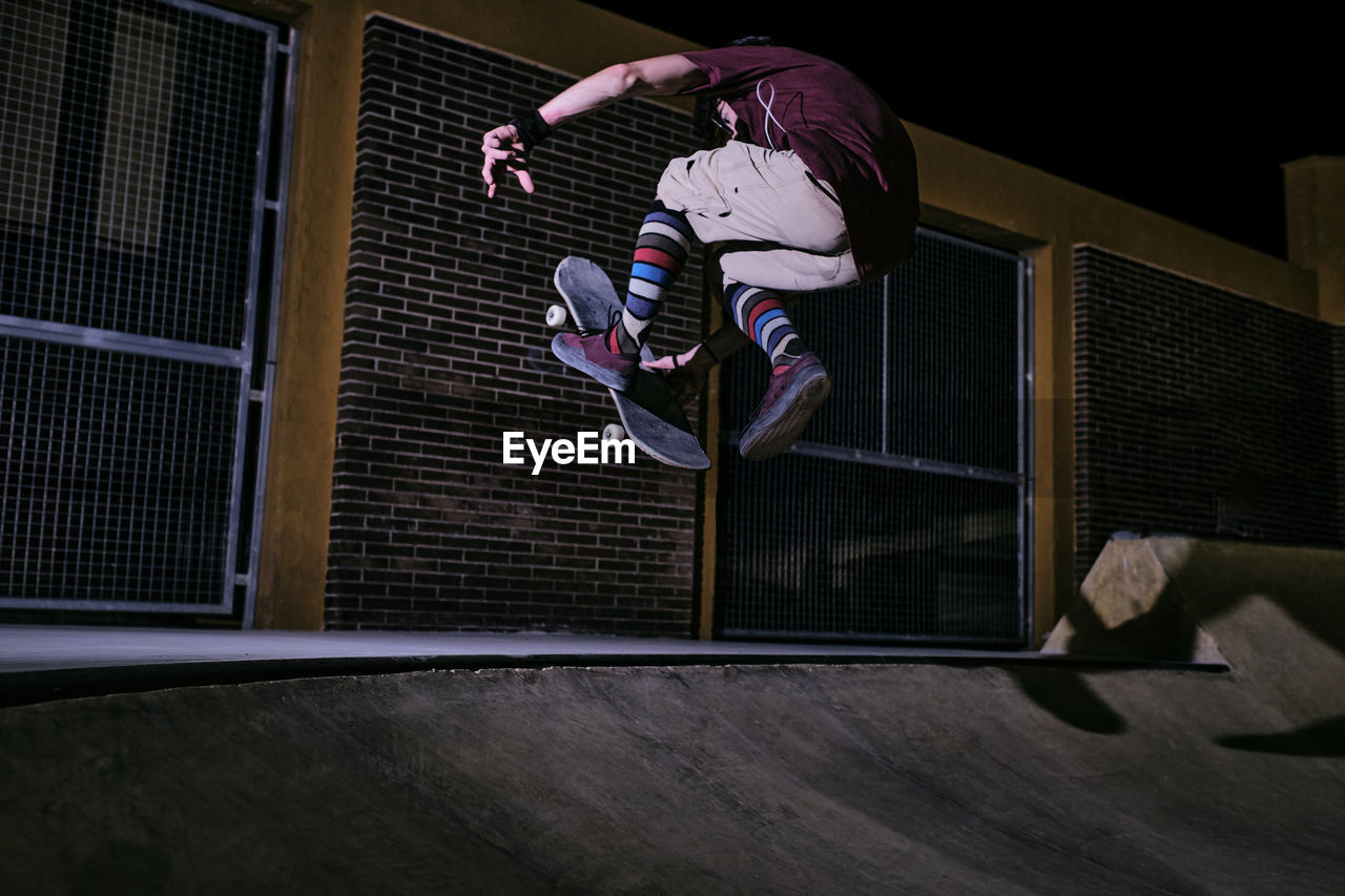 Young white man jumping on his skateboard