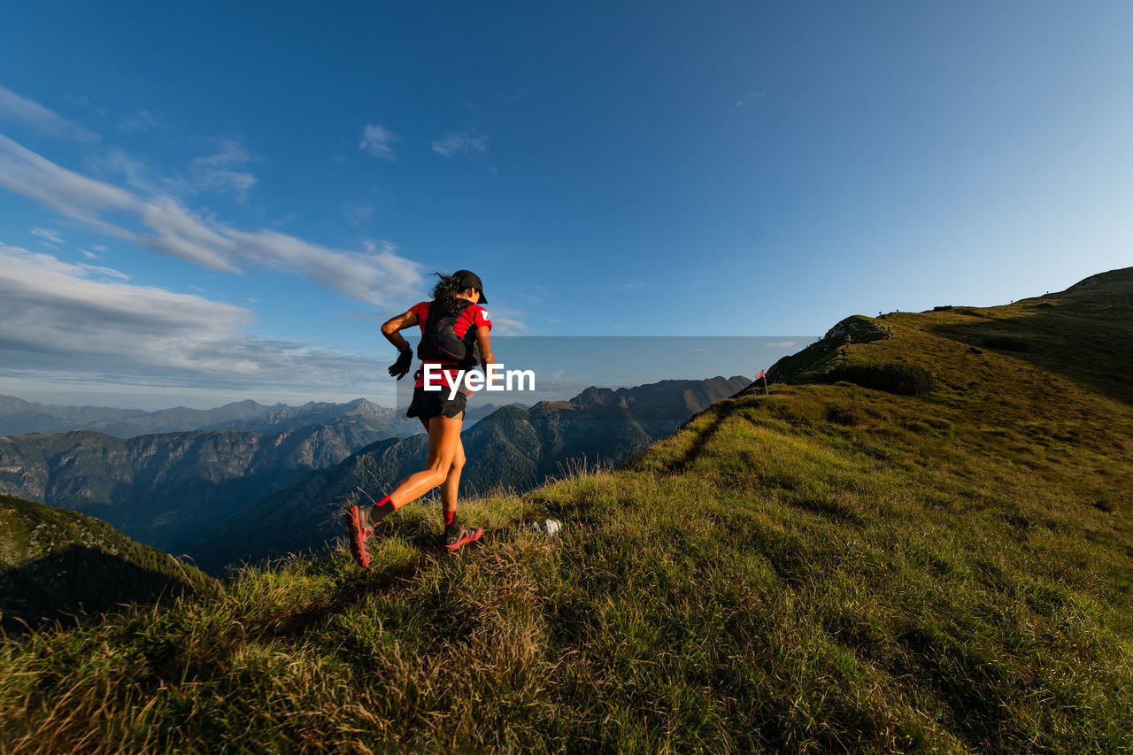 Sporty mountain woman rides in trail during endurance trail