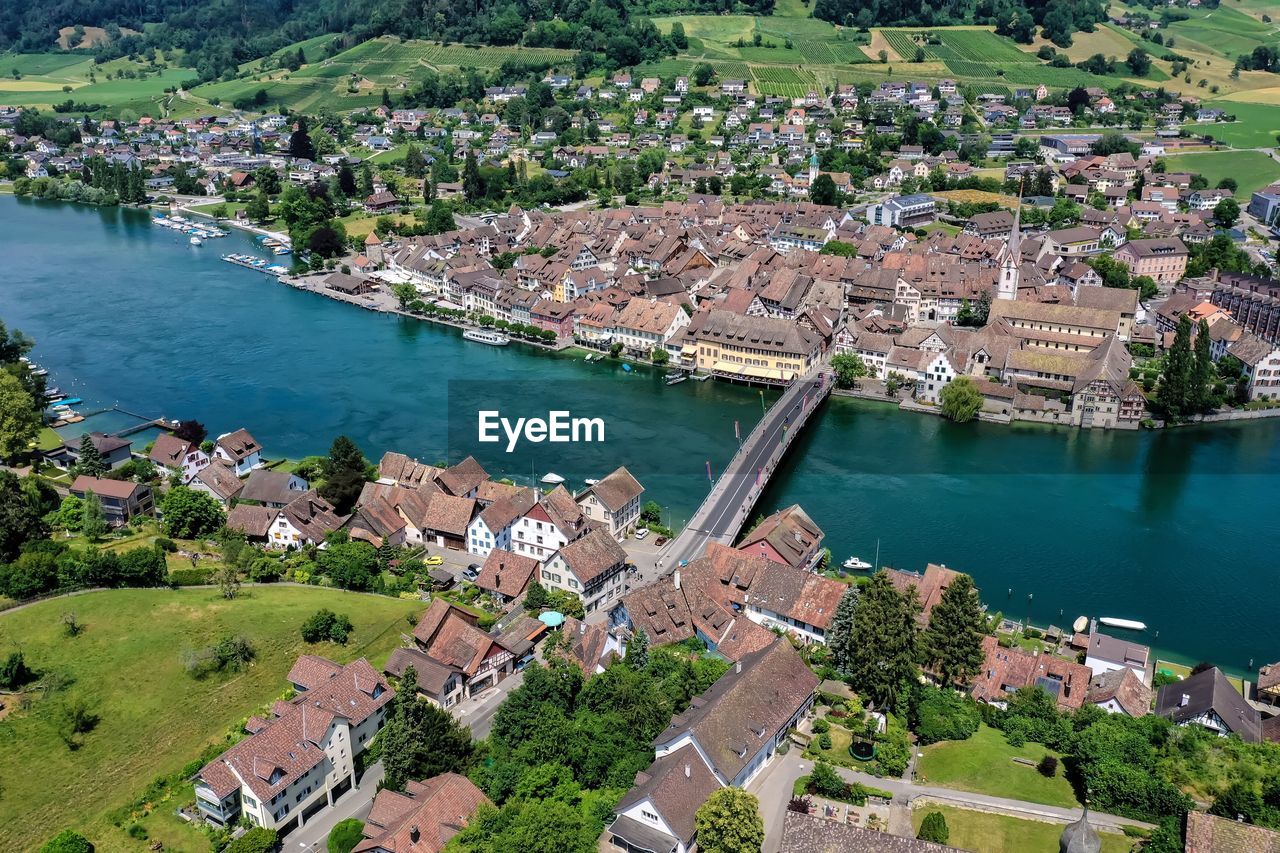 High angle view of townscape by river in city