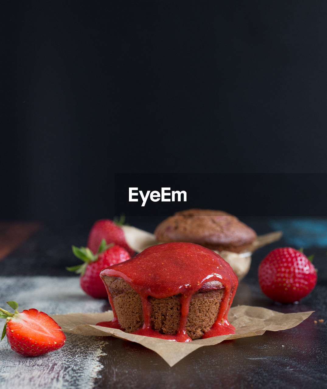 Close-up of muffins with strawberries on table