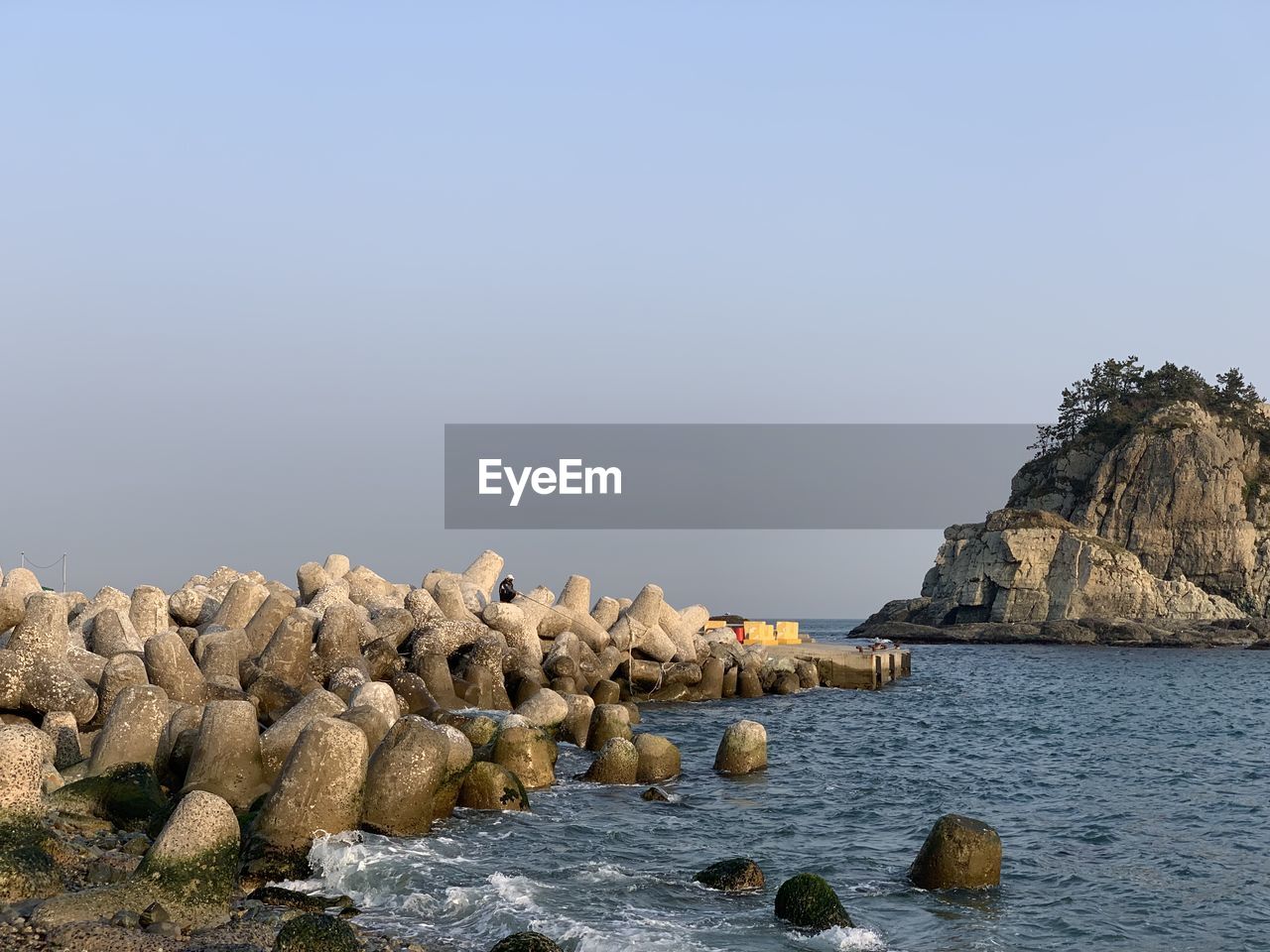 ROCKS ON BEACH AGAINST SKY