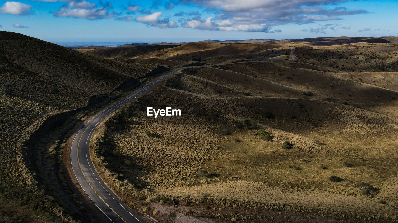 High angle view of road amidst land against sky