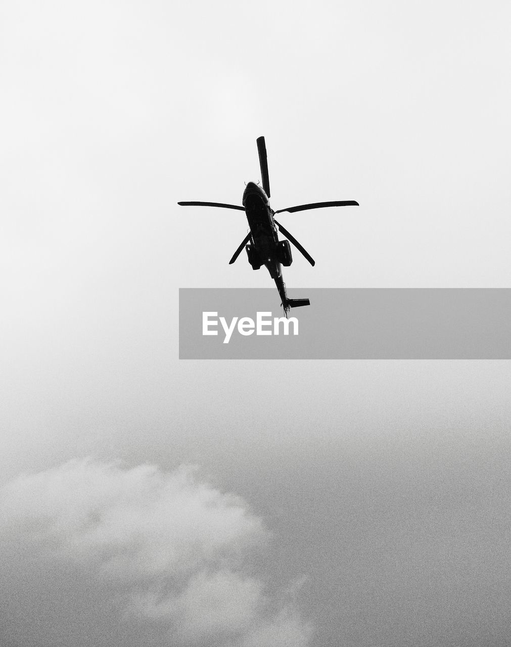 Low angle view of helicopter against sky