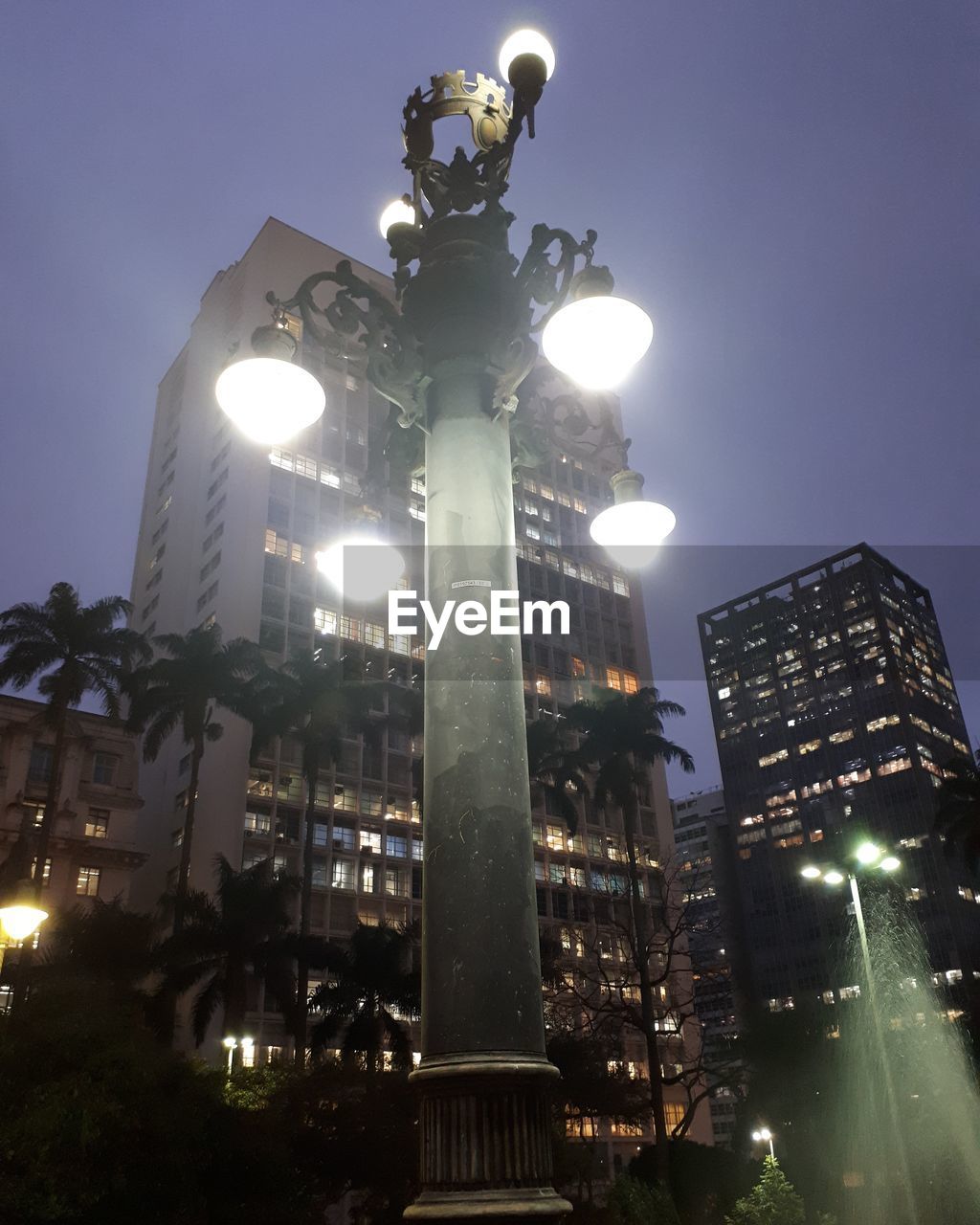 LOW ANGLE VIEW OF ILLUMINATED STREET LIGHT AT NIGHT