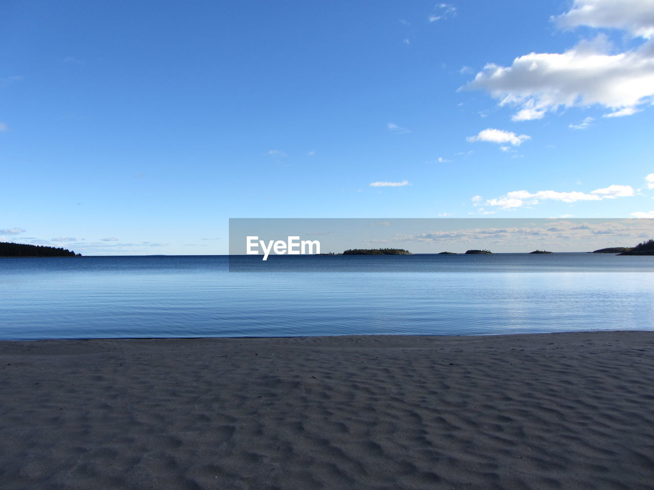 Scenic view of sea against blue sky