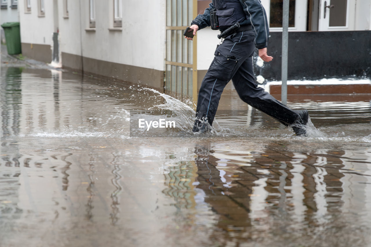 water, wet, one person, men, motion, winter, rain, adult, flood, architecture, puddle, full length, snow, nature, sports, running, outdoors, trousers, splashing, lifestyles, accidents and disasters, day