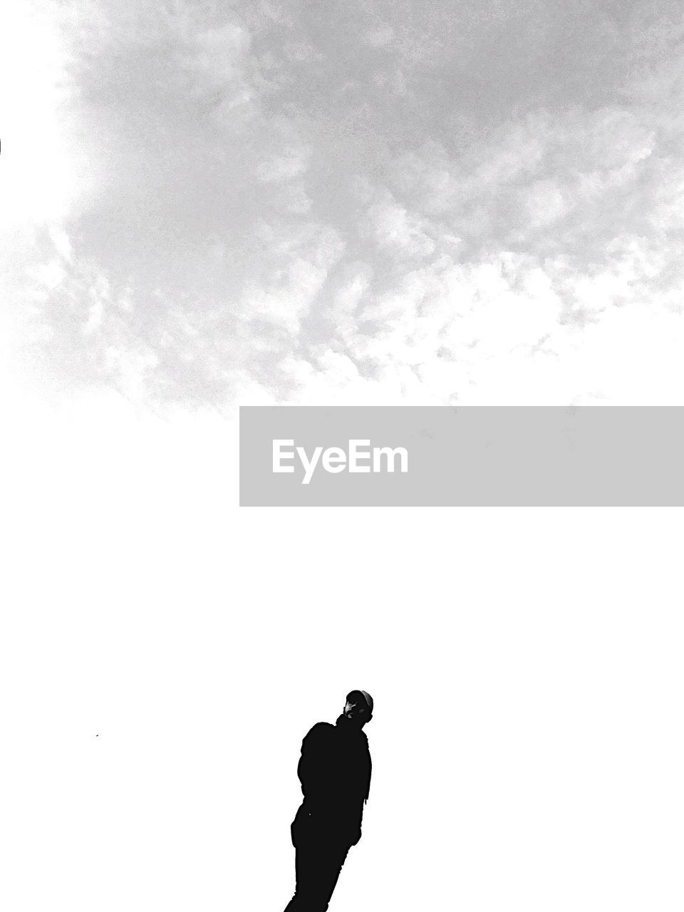 SILHOUETTE OF MAN WITH SKY IN BACKGROUND