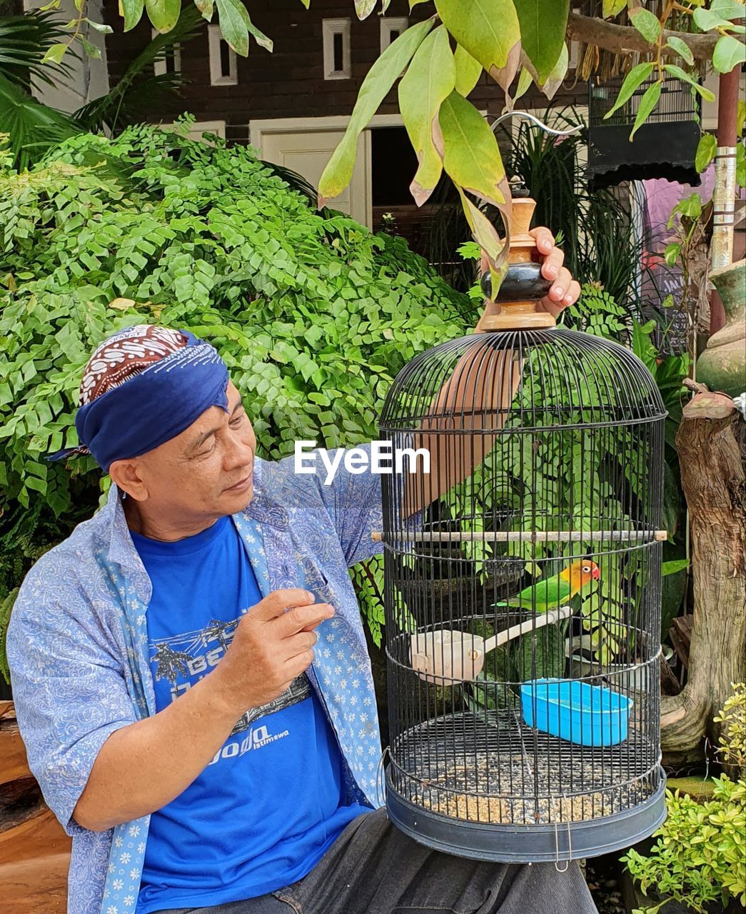 MAN HOLDING UMBRELLA WITH PLANTS