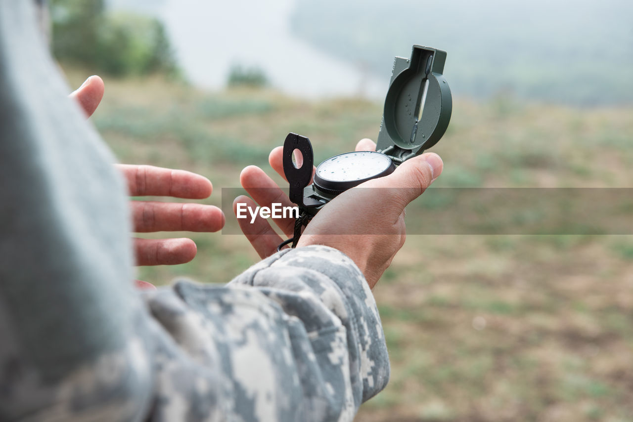 CLOSE-UP OF MAN HOLDING CAMERA