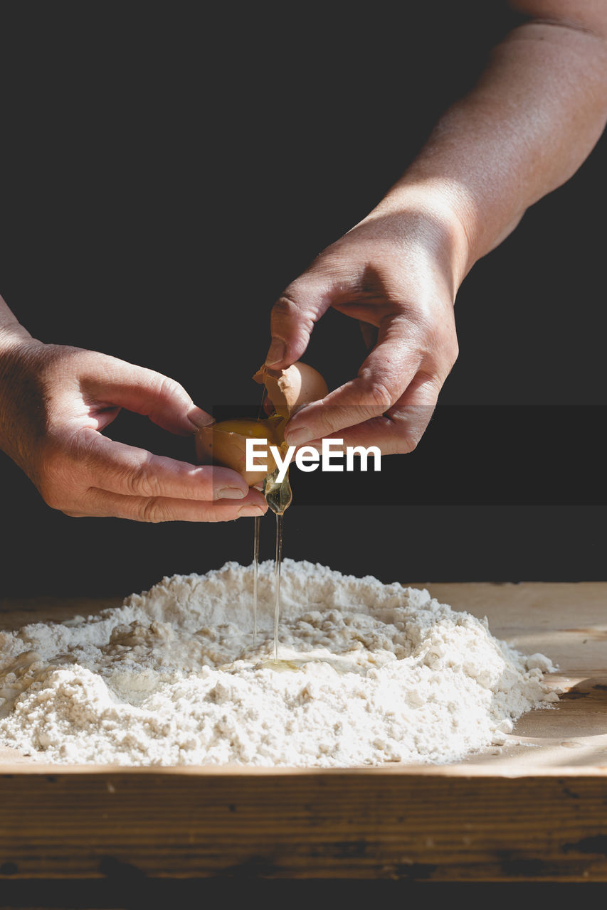 Close-up of hands preparing dough