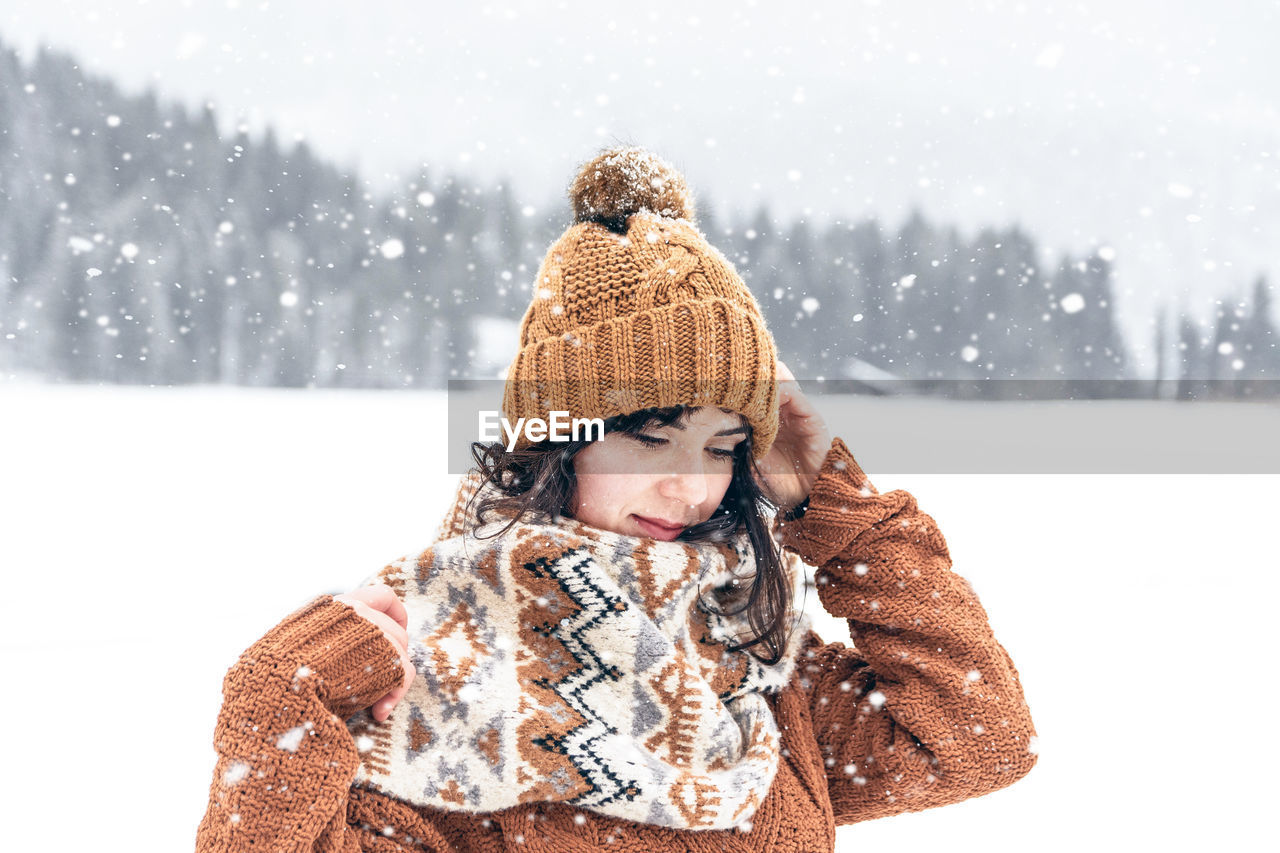Portrait of a young woman in winter. outdoors, snowy day, cold weather.