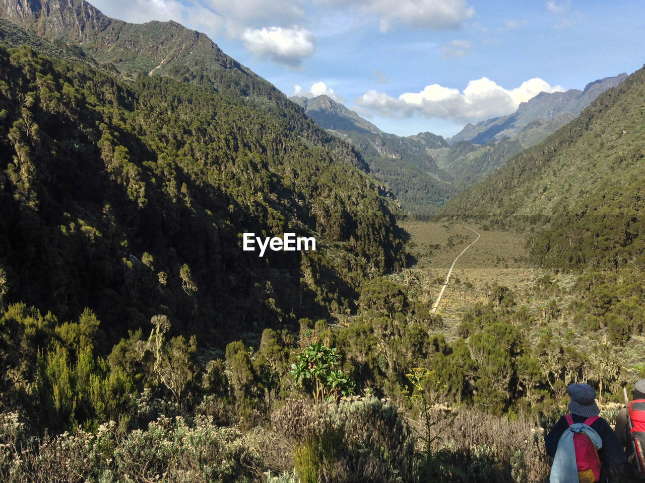 Rear view of people on mountain against sky