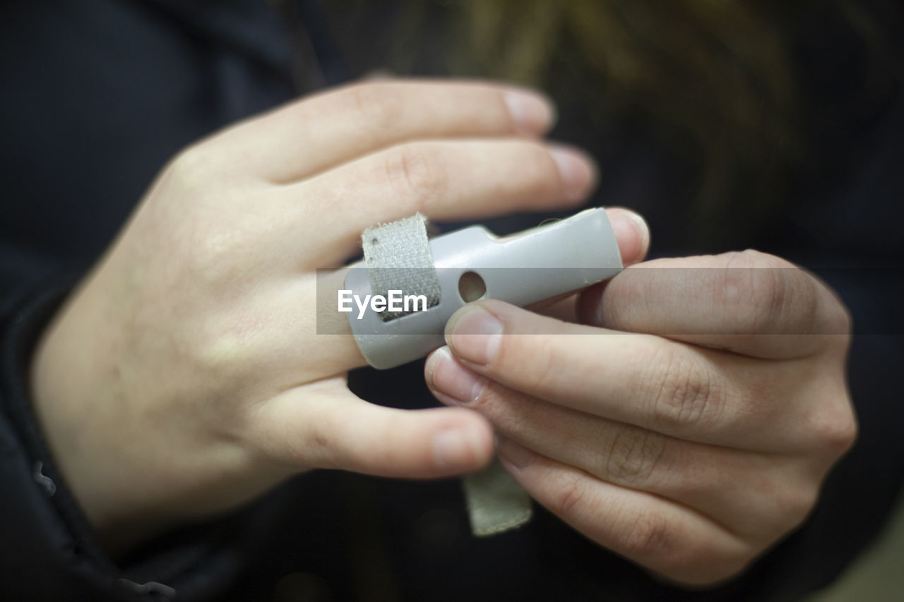 Cropped hands of person with medical equipment