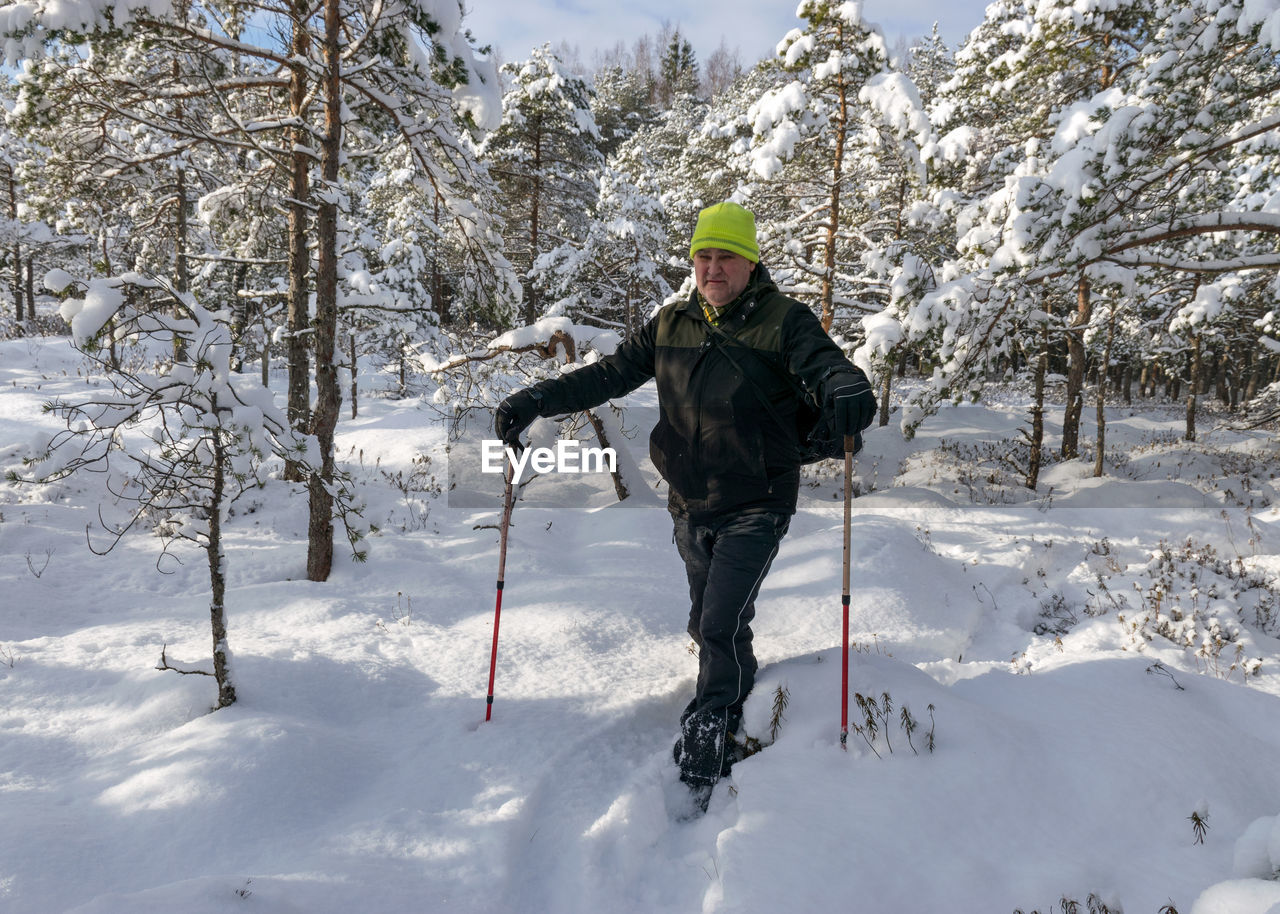 Man standing on snow covered land