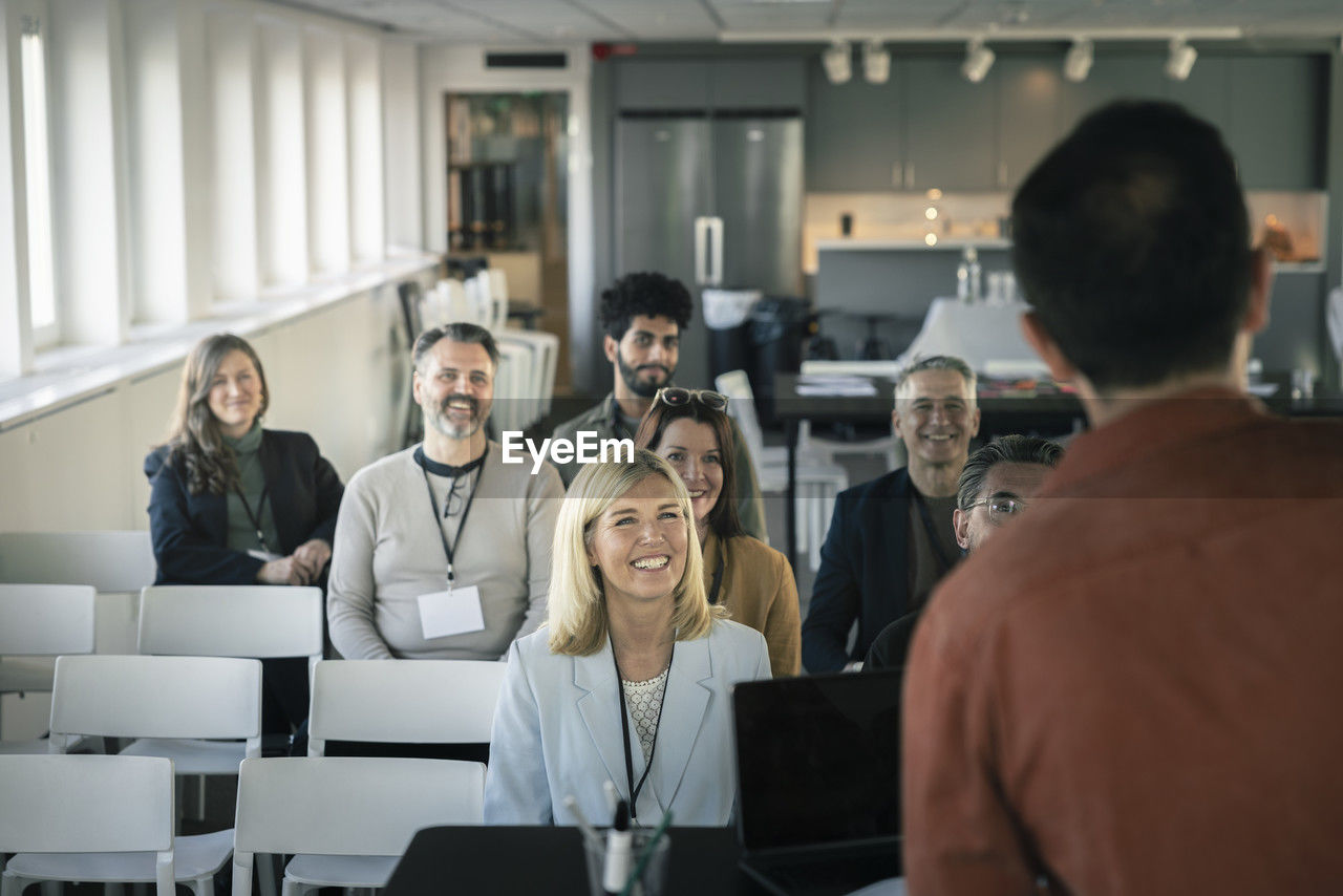 Group of business people attending presentation during conference