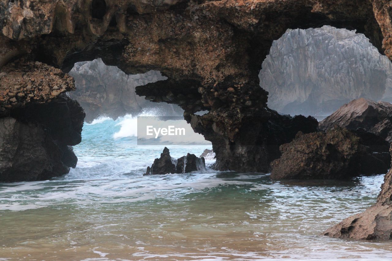 Scenic view of sea and rocks against sky