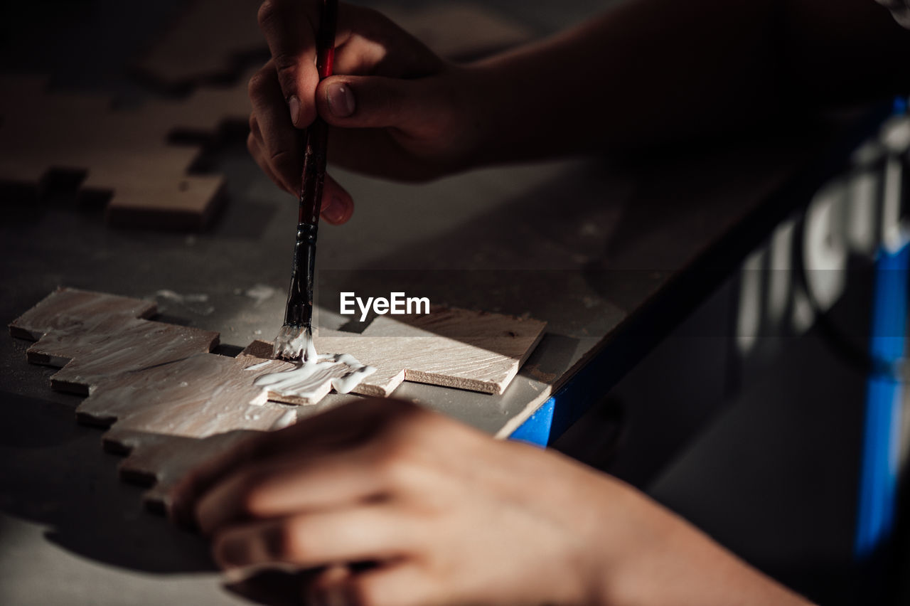 Cropped hand of person working in workshop