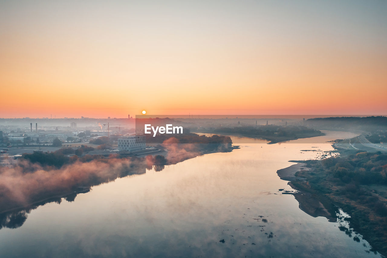 Aerial view of city by river during winter