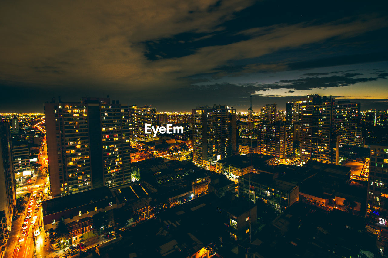 Aerial view of illuminated cityscape against sky at night