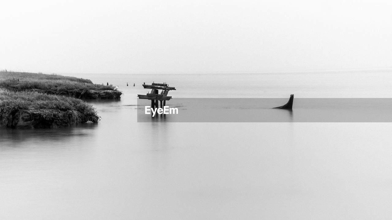 water, black and white, sky, sea, nature, monochrome photography, tranquility, monochrome, scenics - nature, reflection, beauty in nature, day, tranquil scene, horizon over water, horizon, transportation, men, nautical vessel, copy space, clear sky, outdoors, waterfront, land, beach, non-urban scene, mode of transportation, two people, travel, idyllic, shore, silhouette