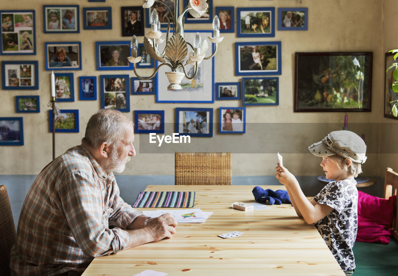 Grandfather and boy playing cards