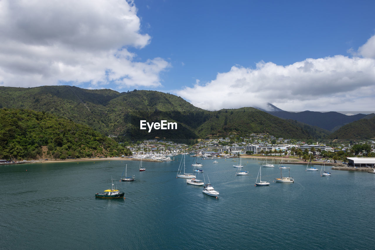 New zealand, marlborough, picton, boats in front of coastal town