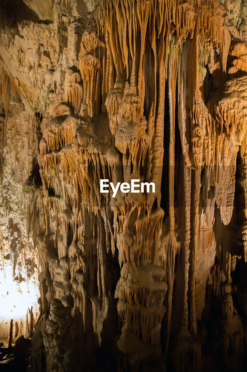 LOW ANGLE VIEW OF ROCK FORMATIONS AT CAVE