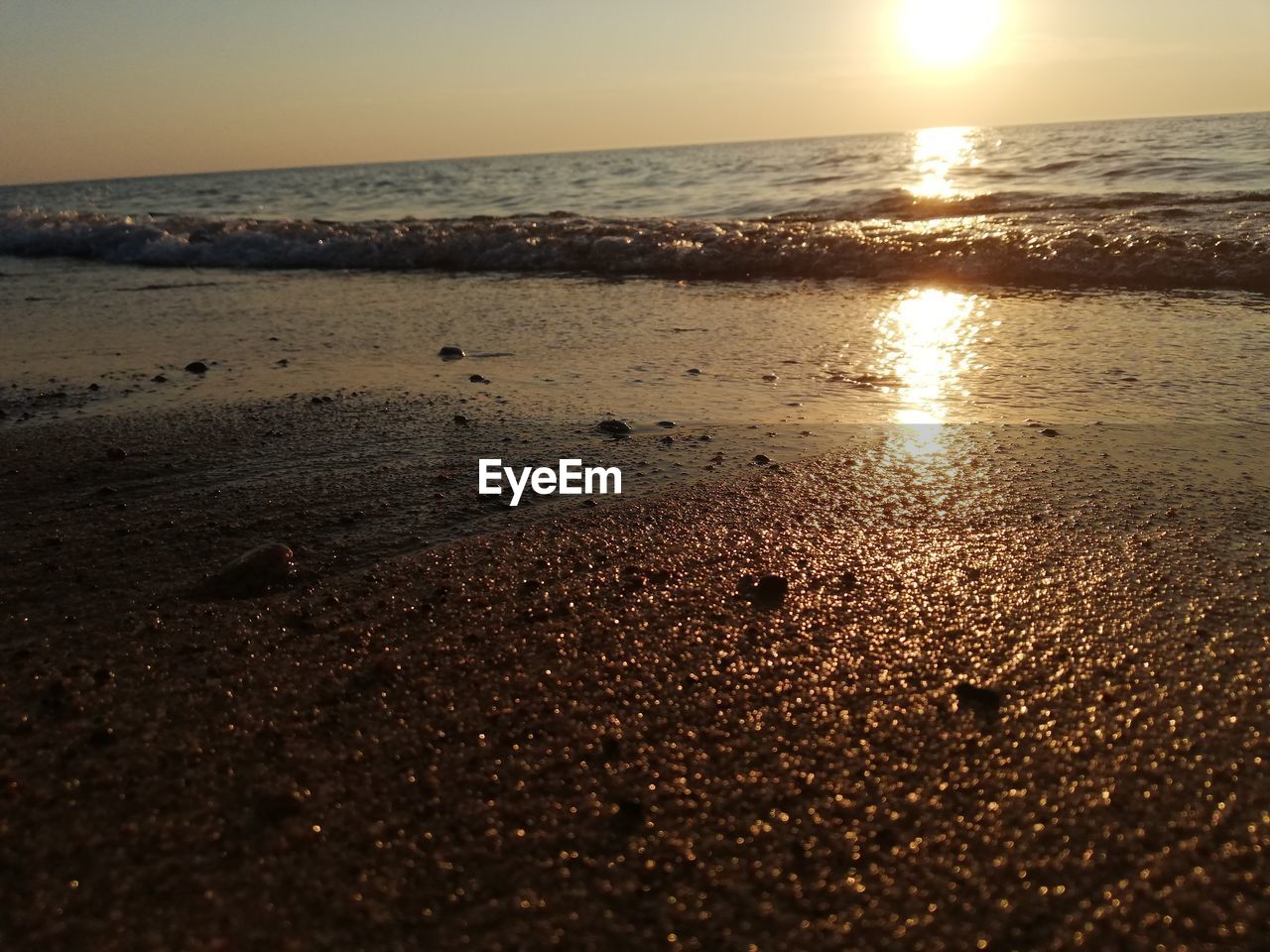 SCENIC VIEW OF BEACH DURING SUNSET