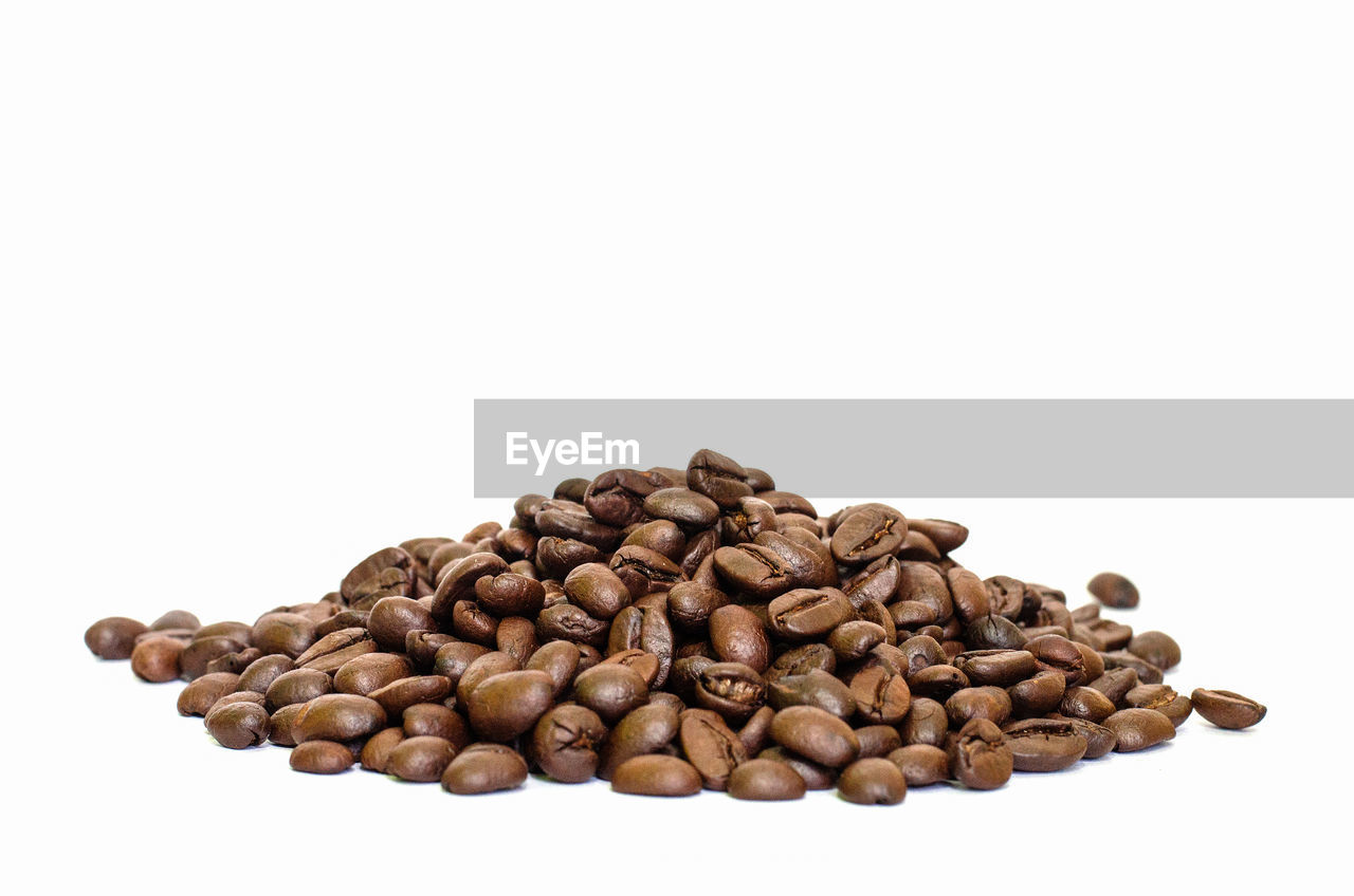 CLOSE-UP OF COFFEE BEANS IN BACKGROUND