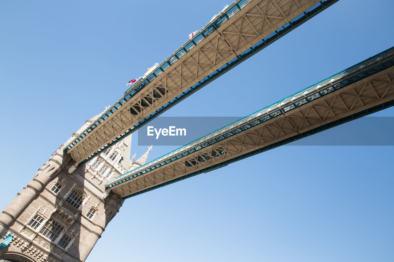 Low angle view of tower bridge against clear blue sky