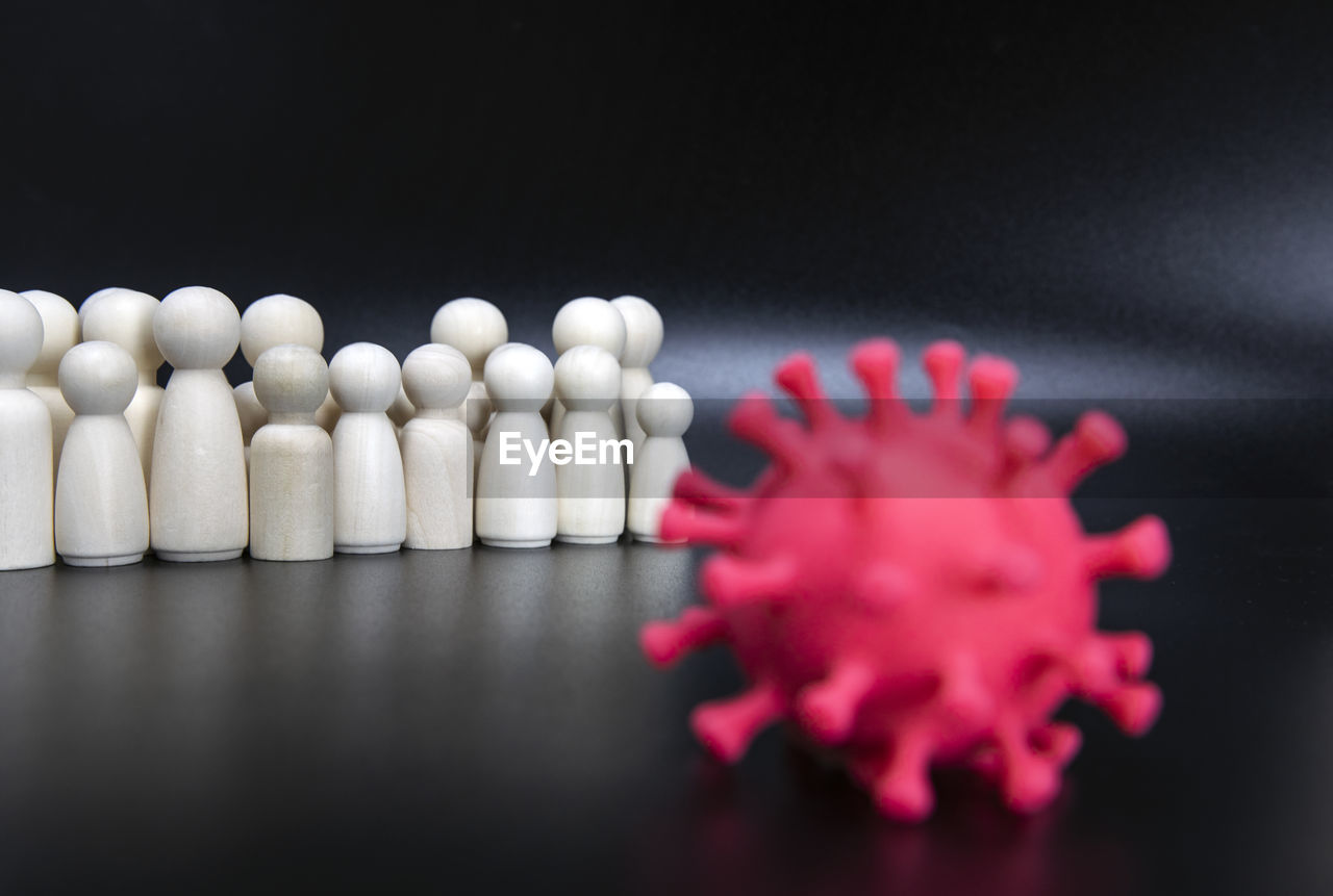 black background, hand, studio shot, indoors, close-up, healthcare and medicine, macro photography, petal, large group of objects, selective focus, still life