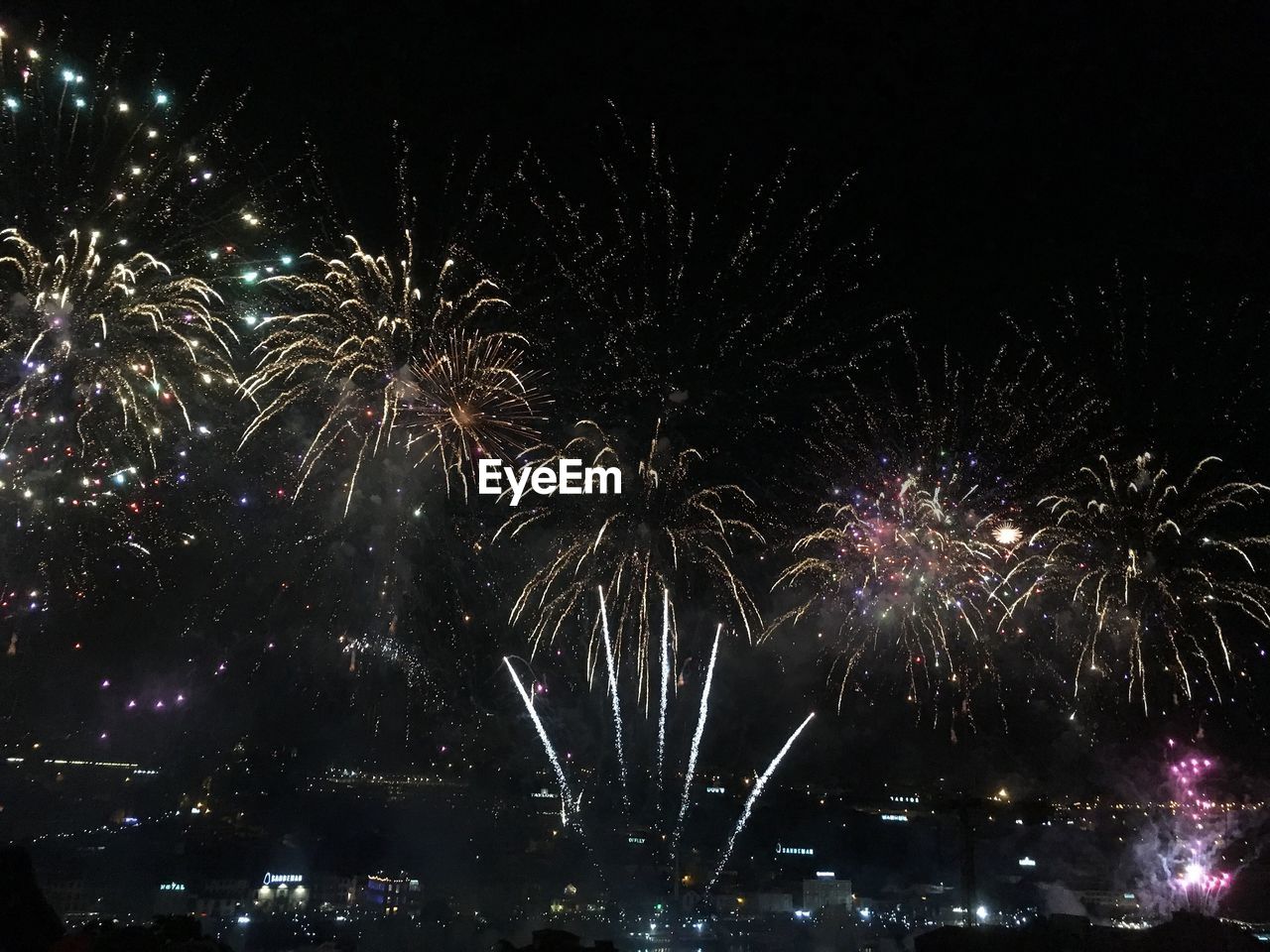 LOW ANGLE VIEW OF FIREWORKS IN SKY AT NIGHT