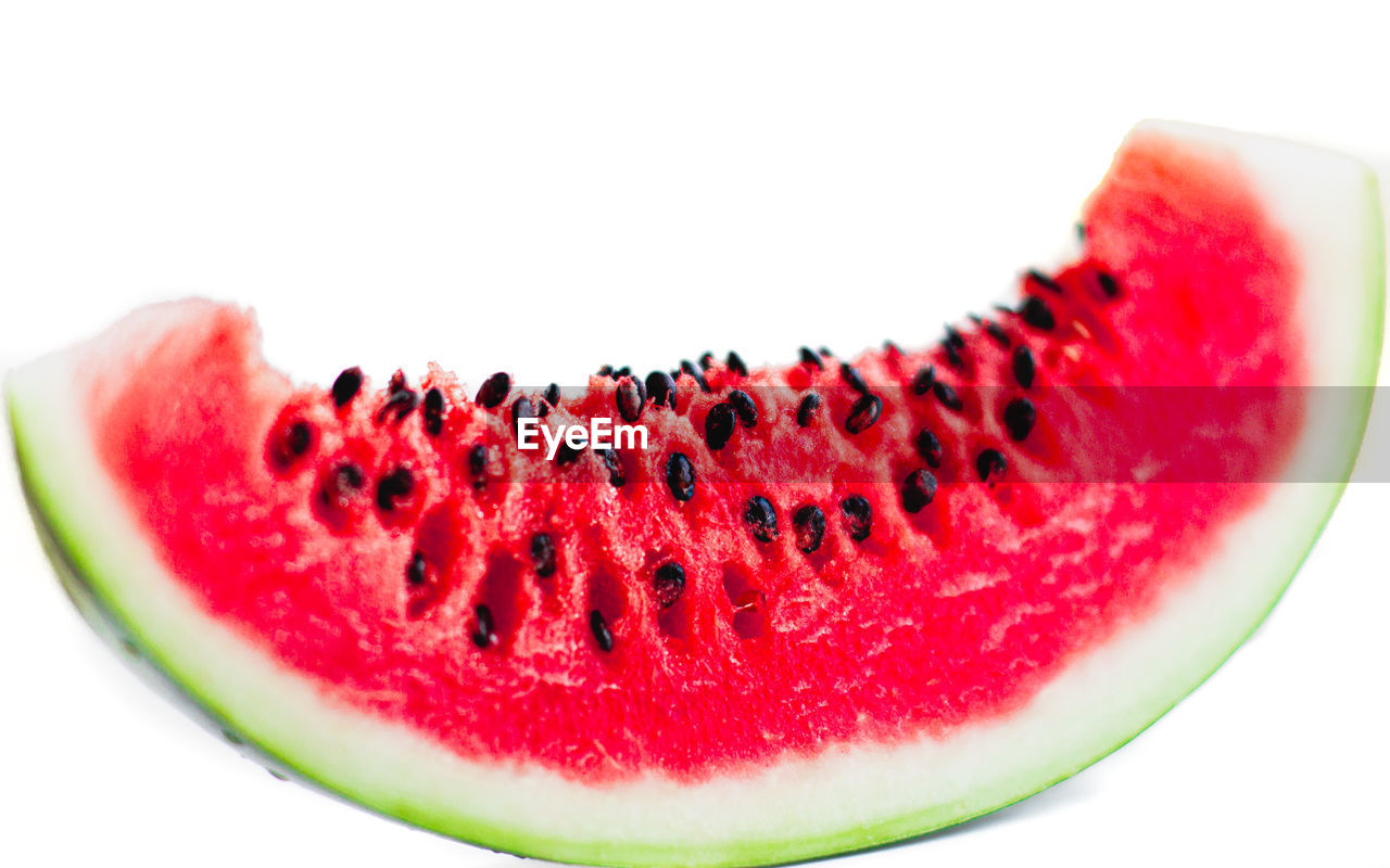 CLOSE-UP OF RED FRUIT AGAINST WHITE BACKGROUND