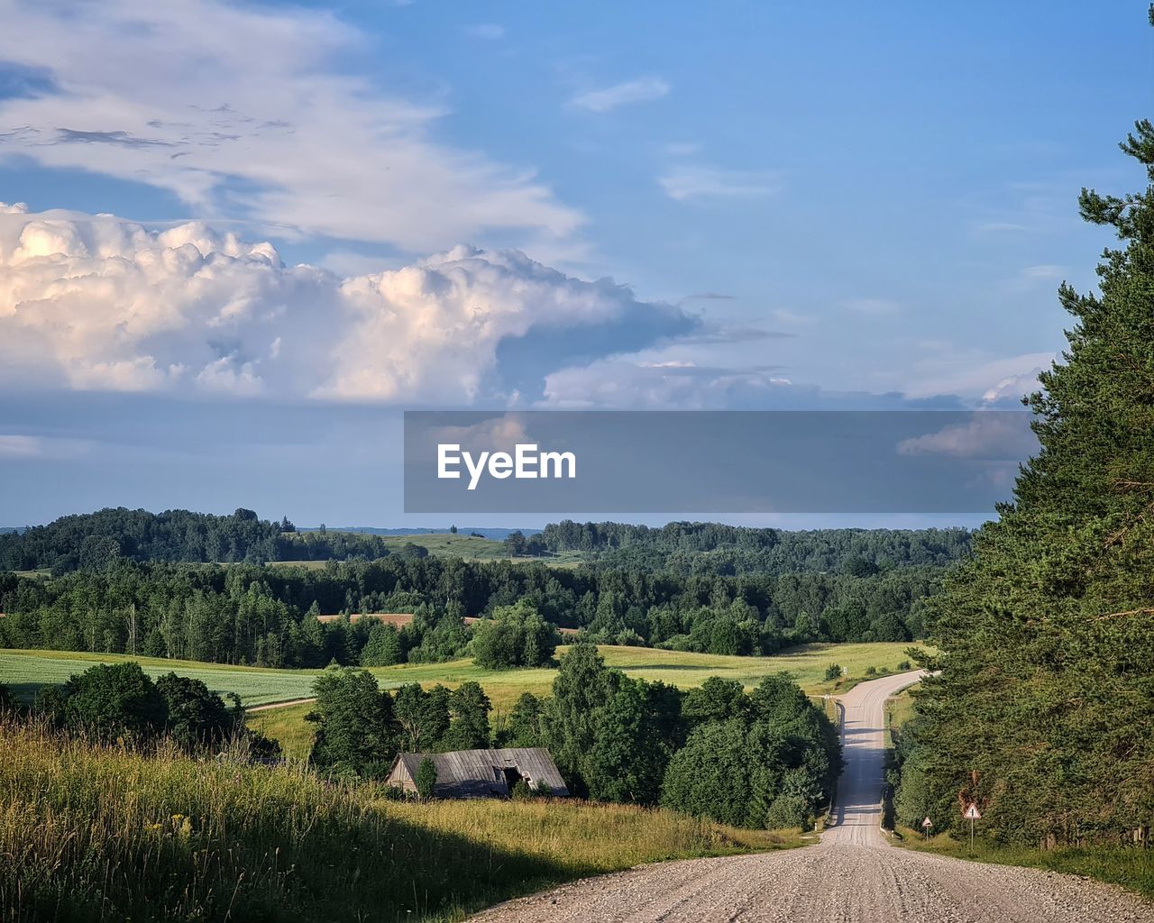 Idyllic countryside road with impressiove clouds above