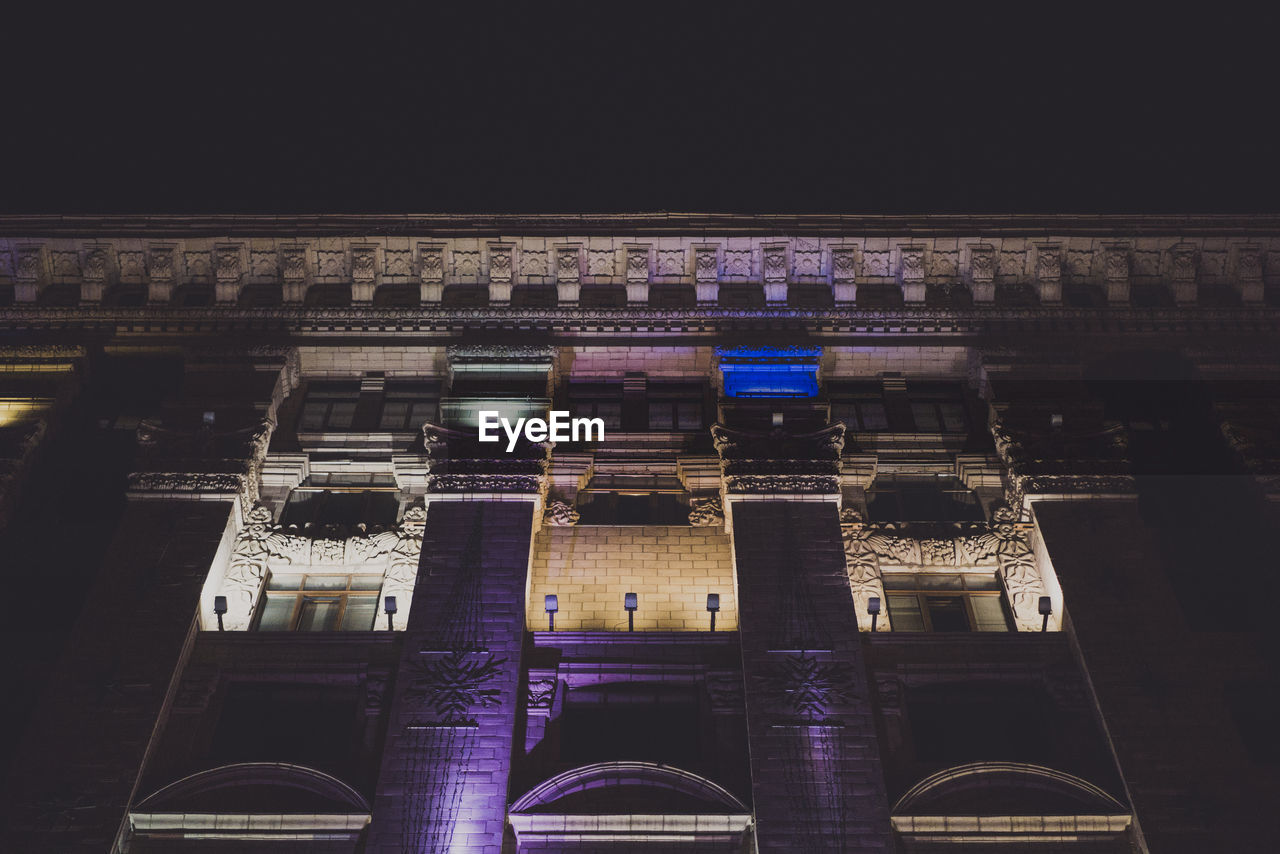 Low angle view of illuminated building at night