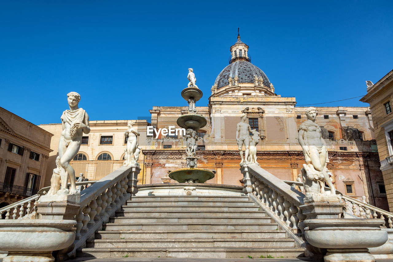 Low angle view of historic building against clear blue sky