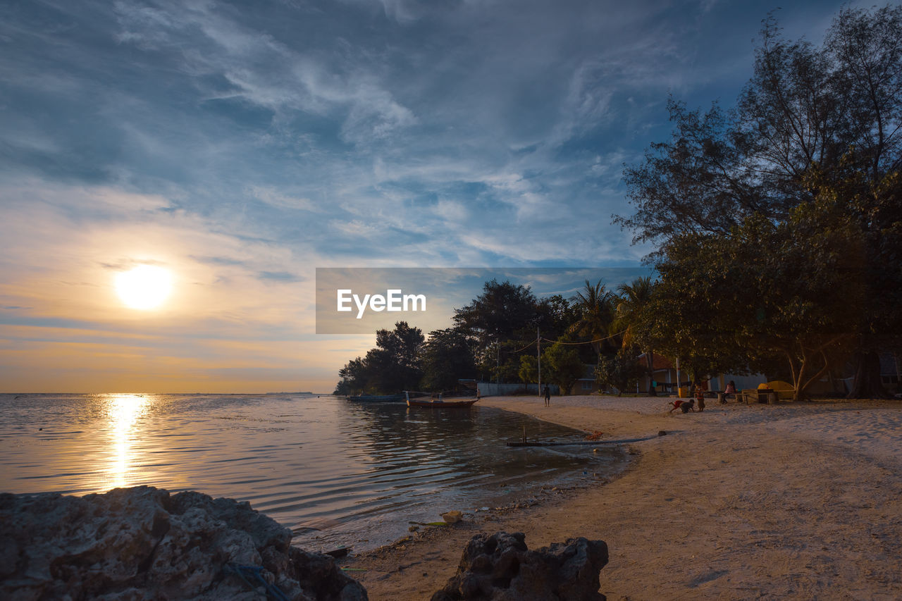 SCENIC VIEW OF SEA AGAINST ORANGE SKY