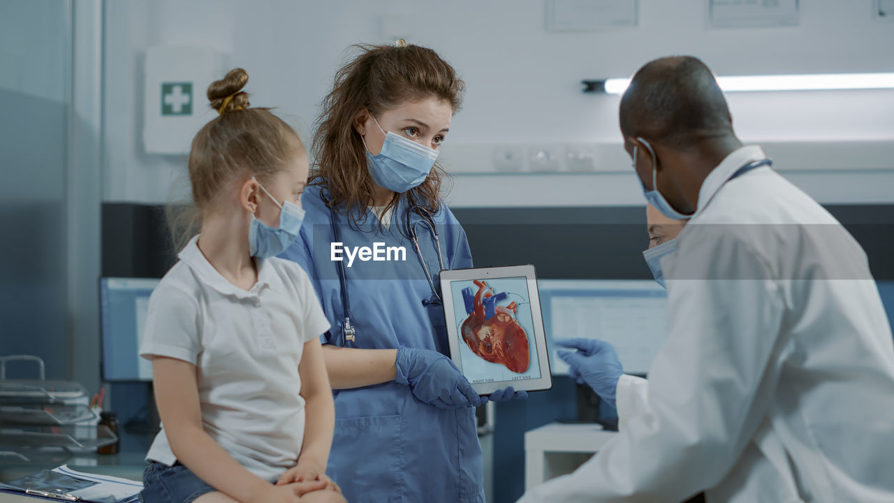 Nurse showing digital tablet in clinic