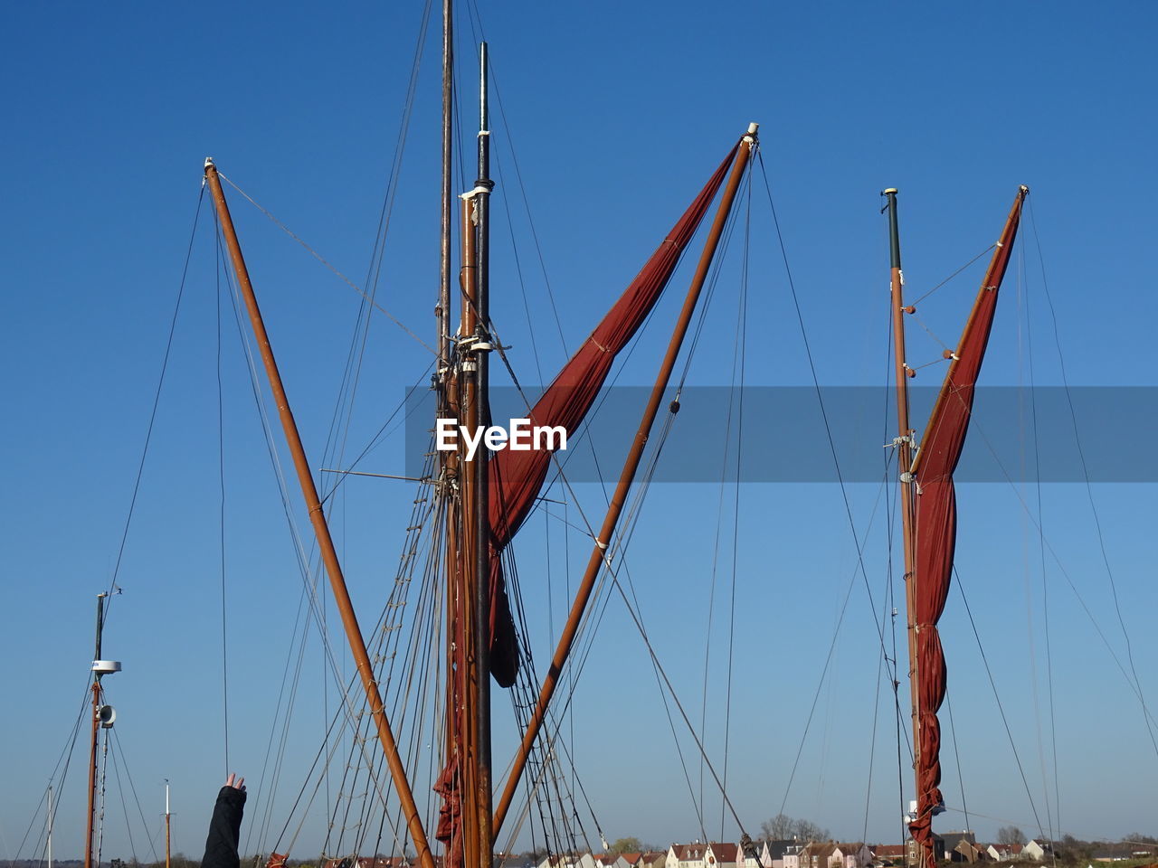 sailboat, nautical vessel, transportation, sky, water, sea, vehicle, sailing, mode of transportation, ship, sailing ship, blue, mast, nature, pole, clear sky, tall ship, no people, harbor, boat, architecture, watercraft, outdoors, travel, day, sunny, windjammer, schooner, rigging