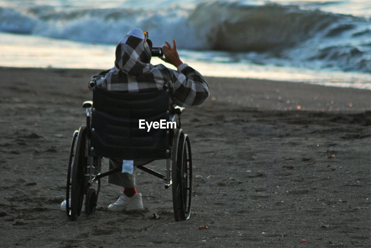 Man in wheelchair on the beach