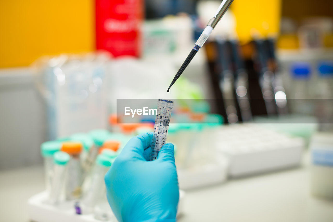 Cropped hand of doctor doing research in laboratory