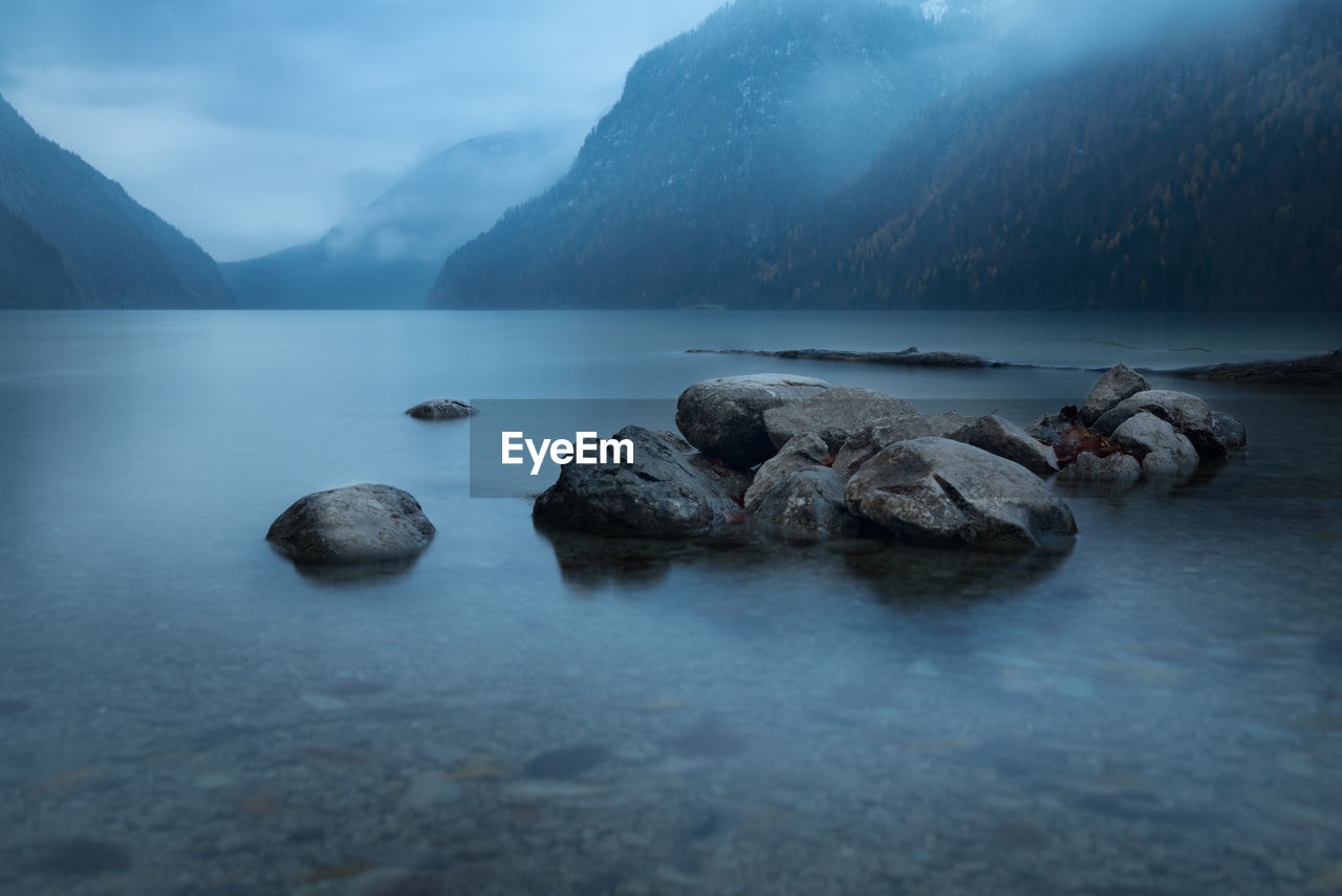 Scenic view of lake and mountains against sky