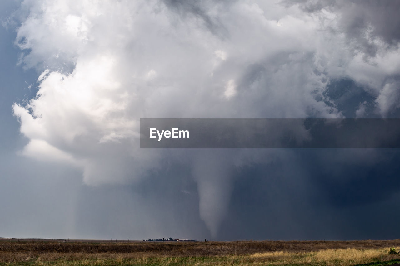 Tornado over landscape against sky