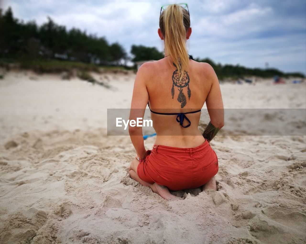 Rear view of young woman on beach