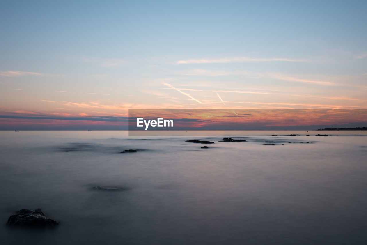 SCENIC VIEW OF SEA AT SUNSET