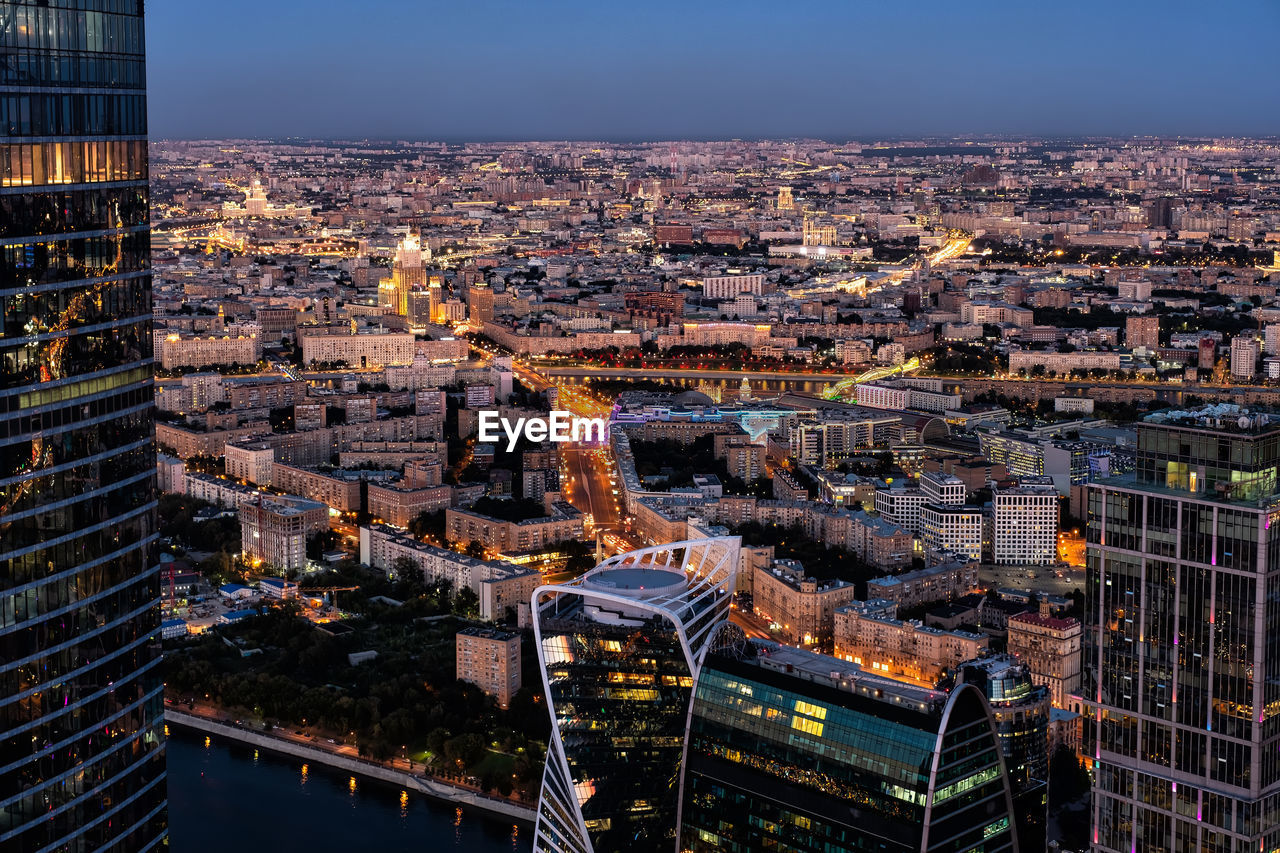 Aerial view of illuminated buildings in city at night